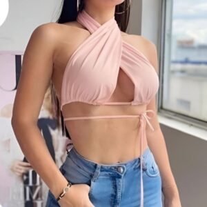 Pink halter top with deep neckline and crisscross neck design