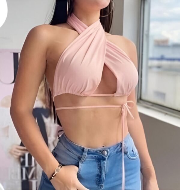 Pink halter top with deep neckline and crisscross neck design